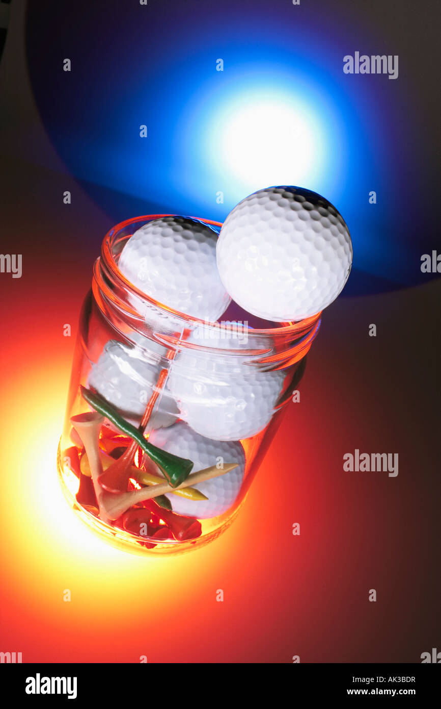 Golf Balls and Tees in Glass Jar Stock Photo