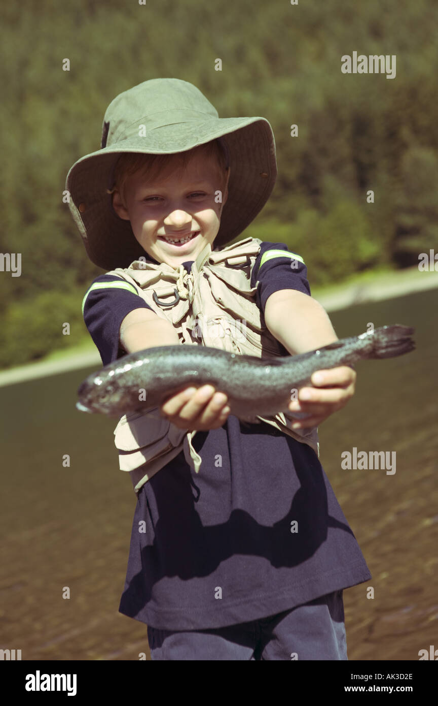 Young boy holding the fish he caught Stock Photo