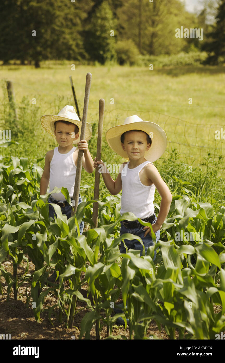 Twin boys working on the family farm Stock Photo