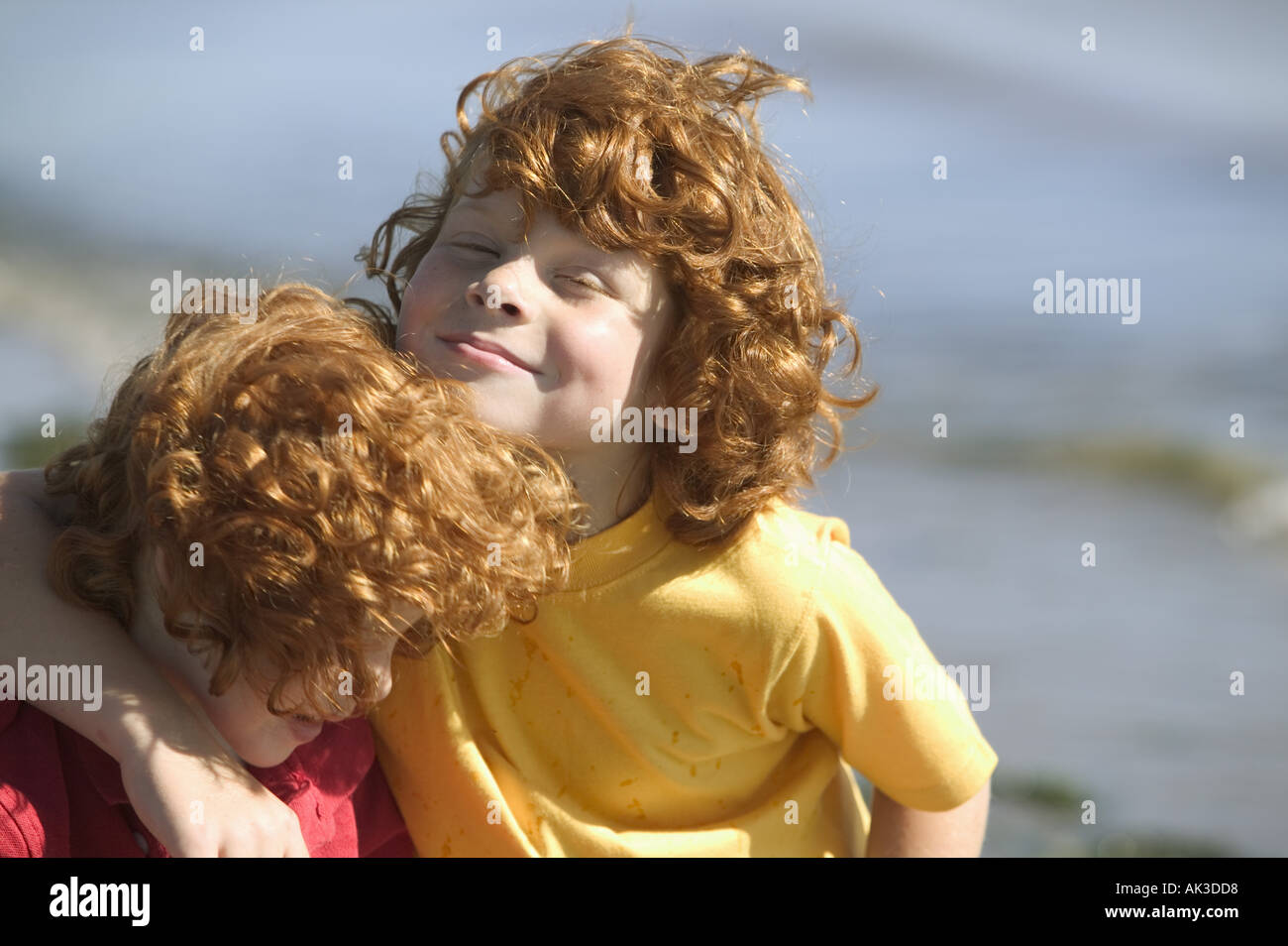 Young red headed brothers on a beach Stock Photo