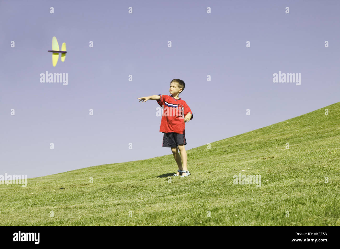 Young boy watching his model plane fly Stock Photo