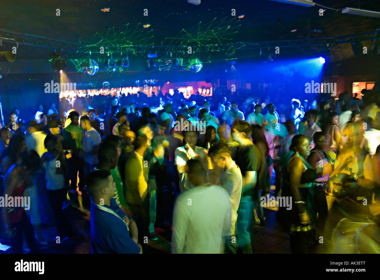 a massive crowd of people dancing together in a night club Stock Photo