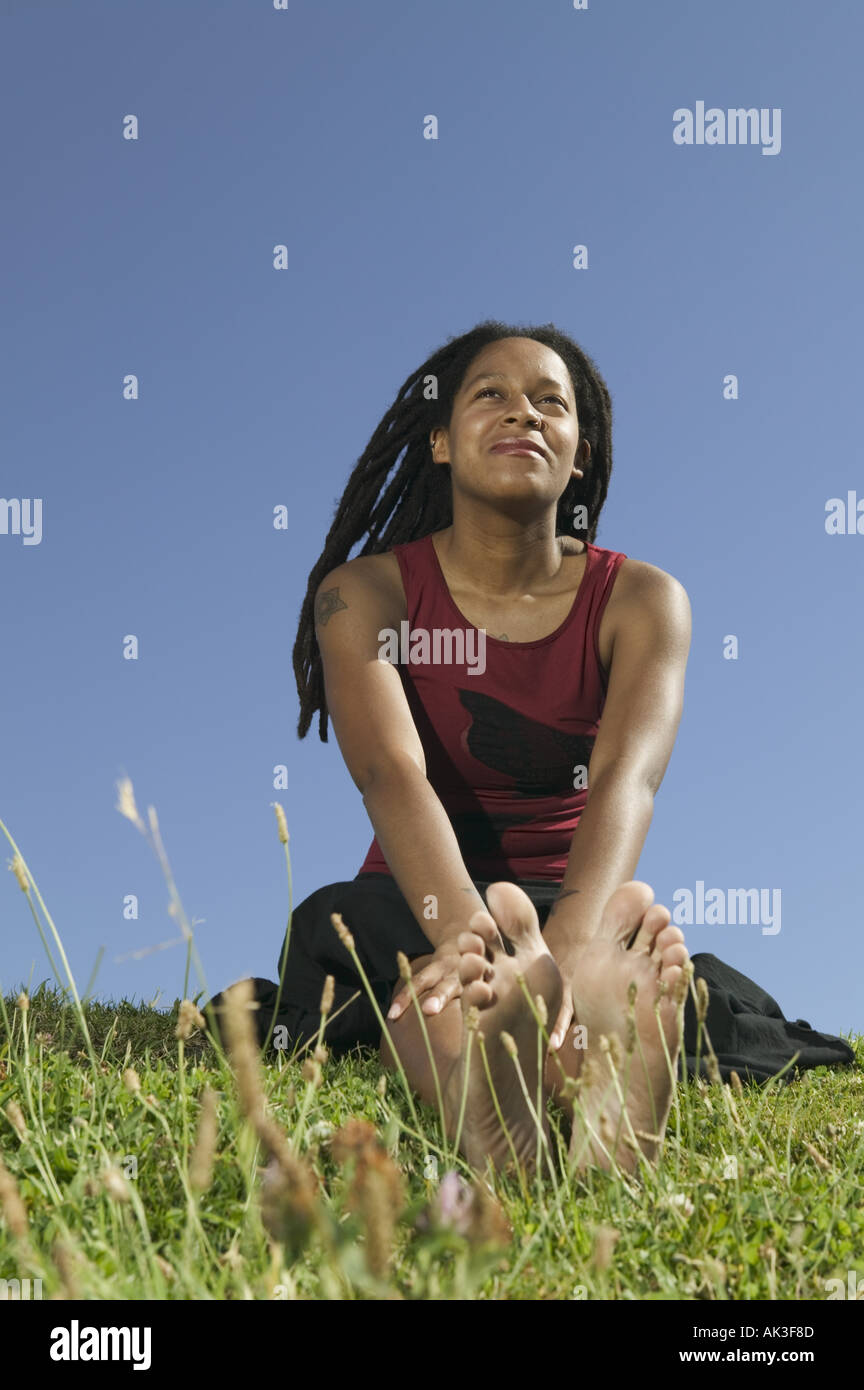 Young woman seated on the grass Stock Photo