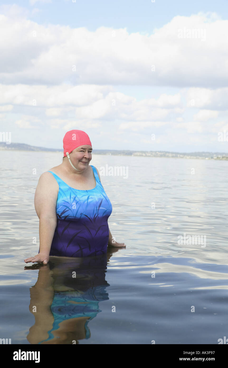Large woman standing in a lake Stock Photo