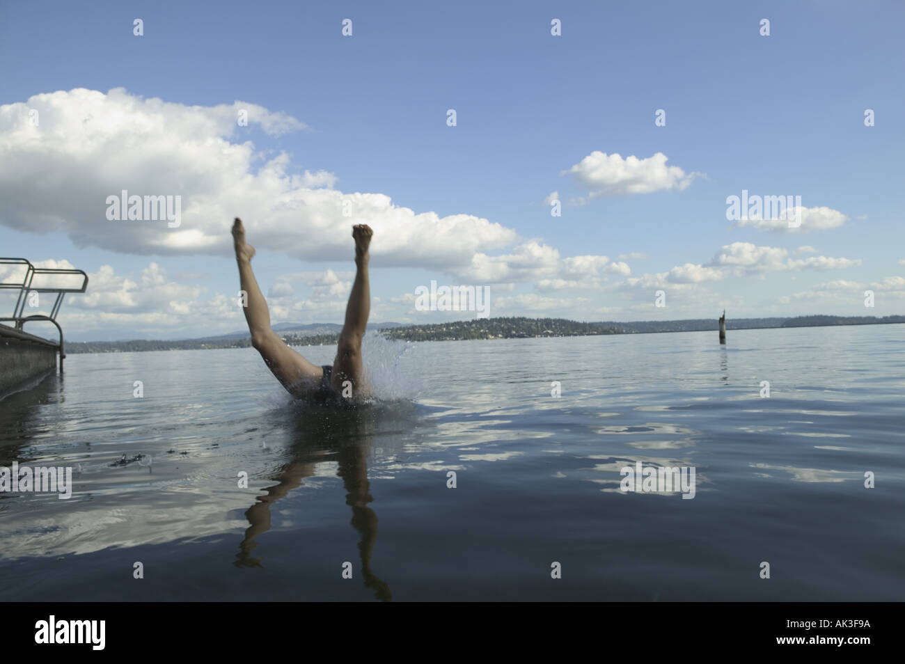 A diver s legs sticking out of a lake Stock Photo