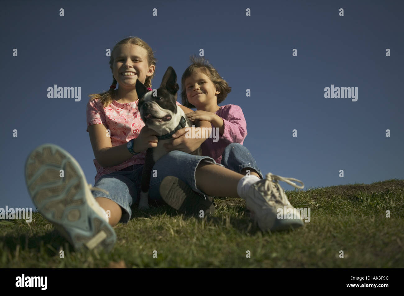 Two young with their pet dog Stock Photo