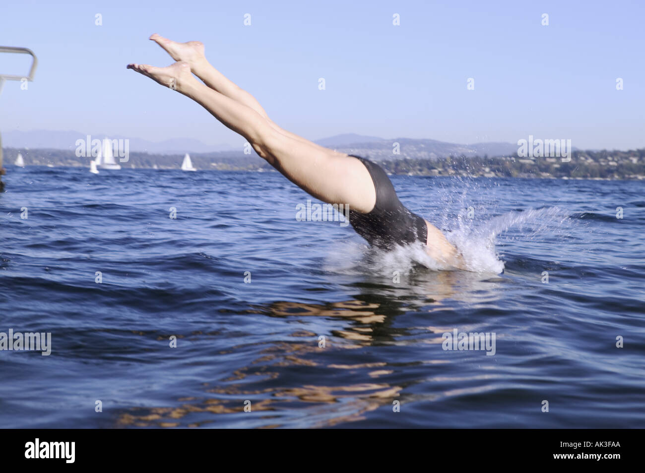A woman diving into a lake Stock Photo