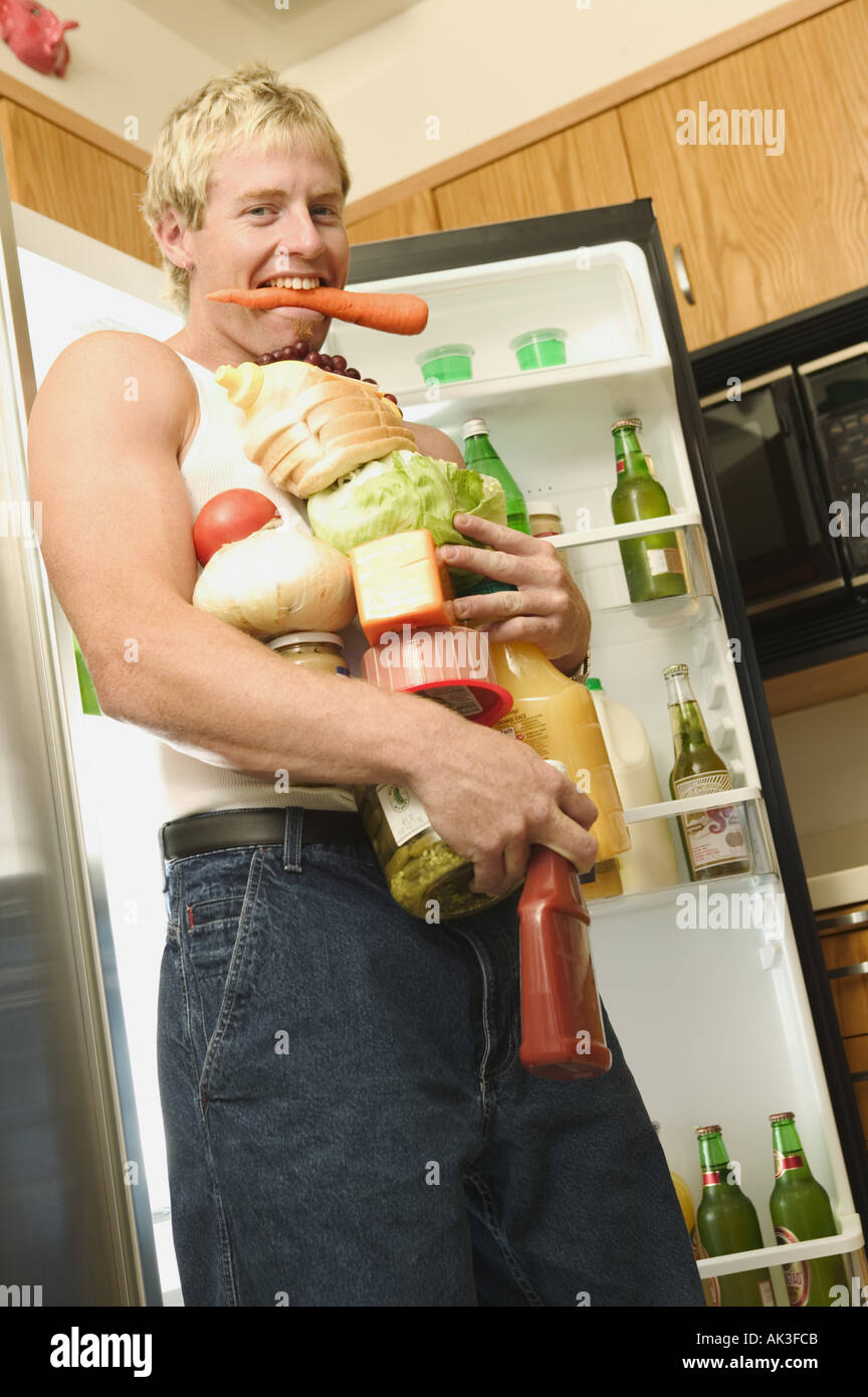 Man with his arms full of food Stock Photo