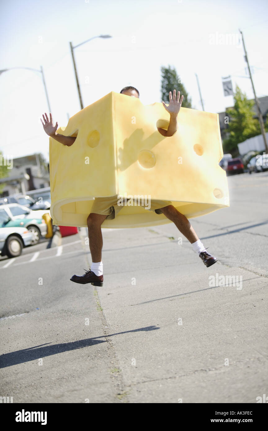 Man in a cheese costume leaping in the air Stock Photo