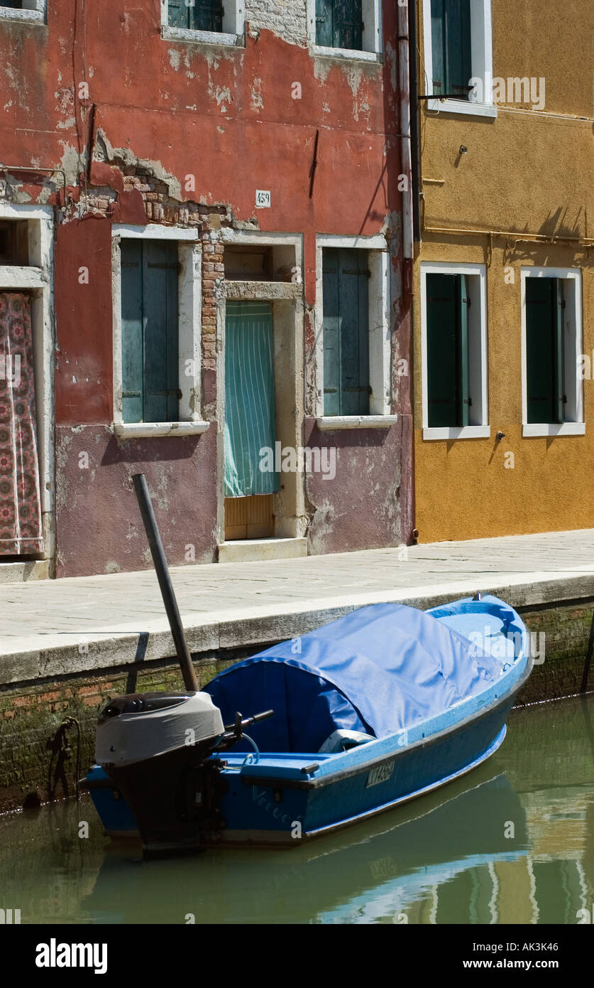 Street with colourful houses and boat on the canal in Burano Venice ...
