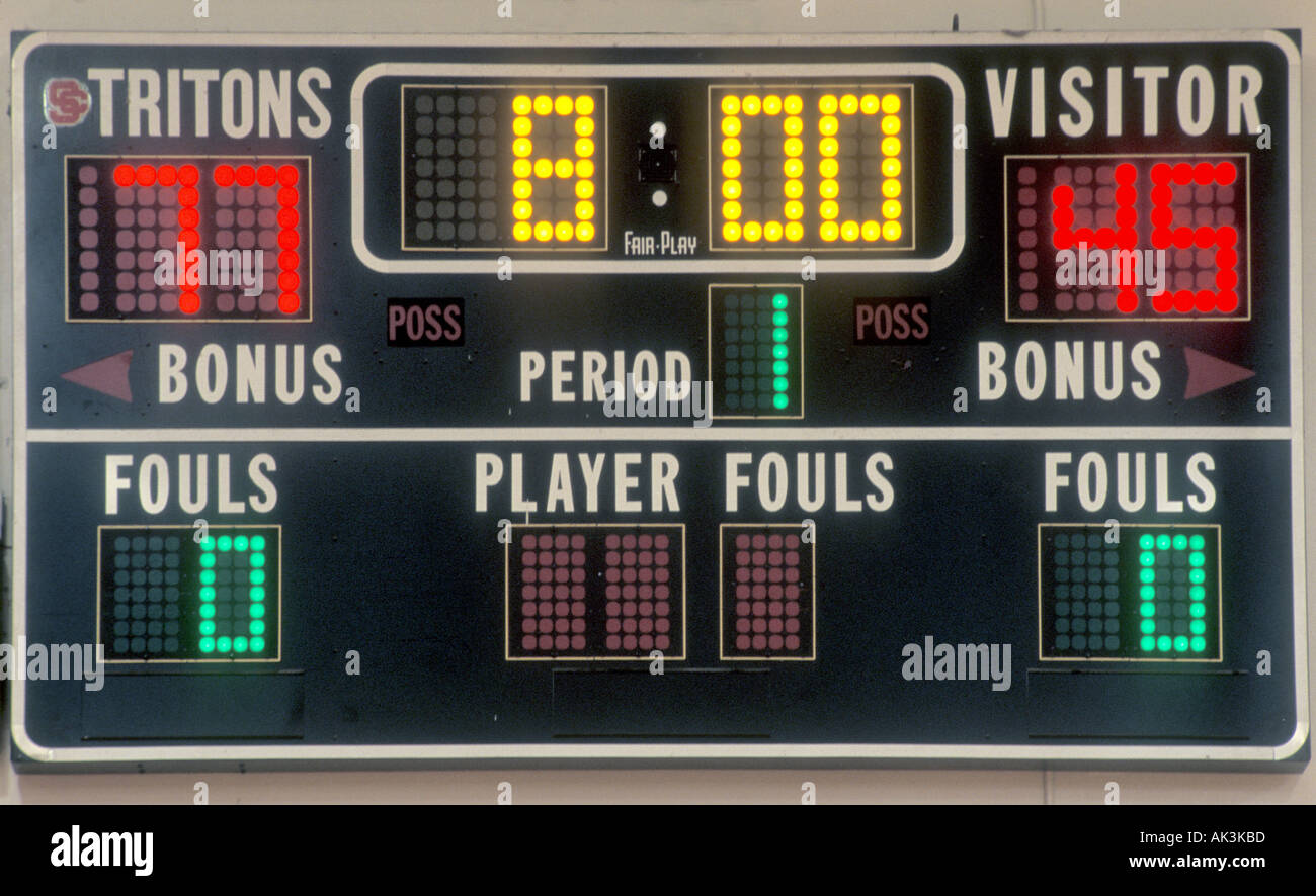 Electric scoreboard in a San Clemente California USA high school gym displays scores for home team Tritons and a visiting team Stock Photo