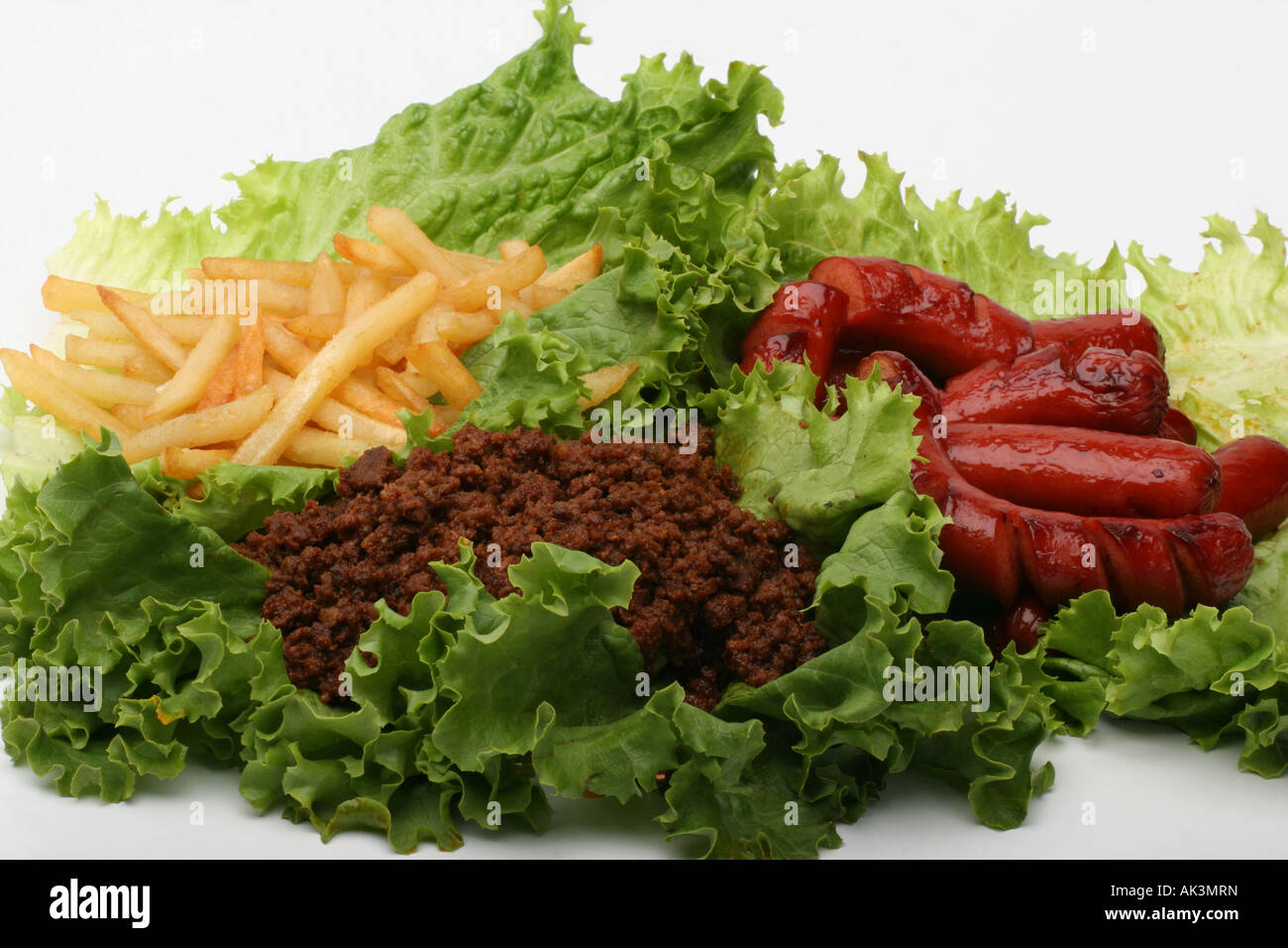 Closeup of roasted roast sausages with French Fries beef red chili fast