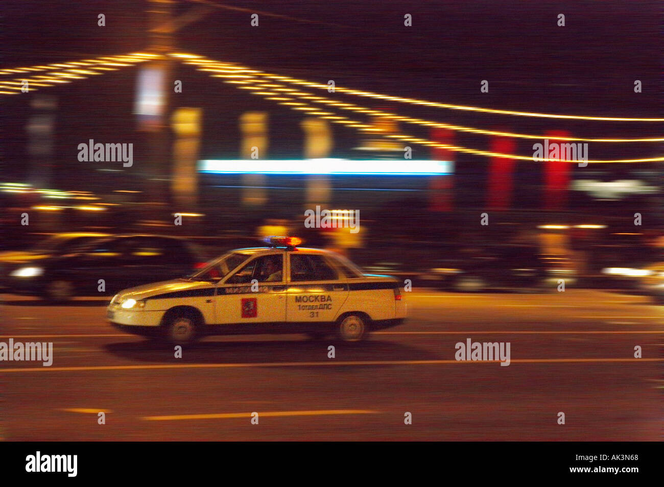 POLICE CAR SPEEDING ACROSS KAMENNY BRIDGE MOSCOW AT NIGHT Stock Photo