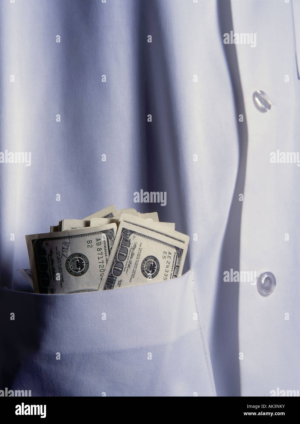 doctor with money in lab coat Stock Photo