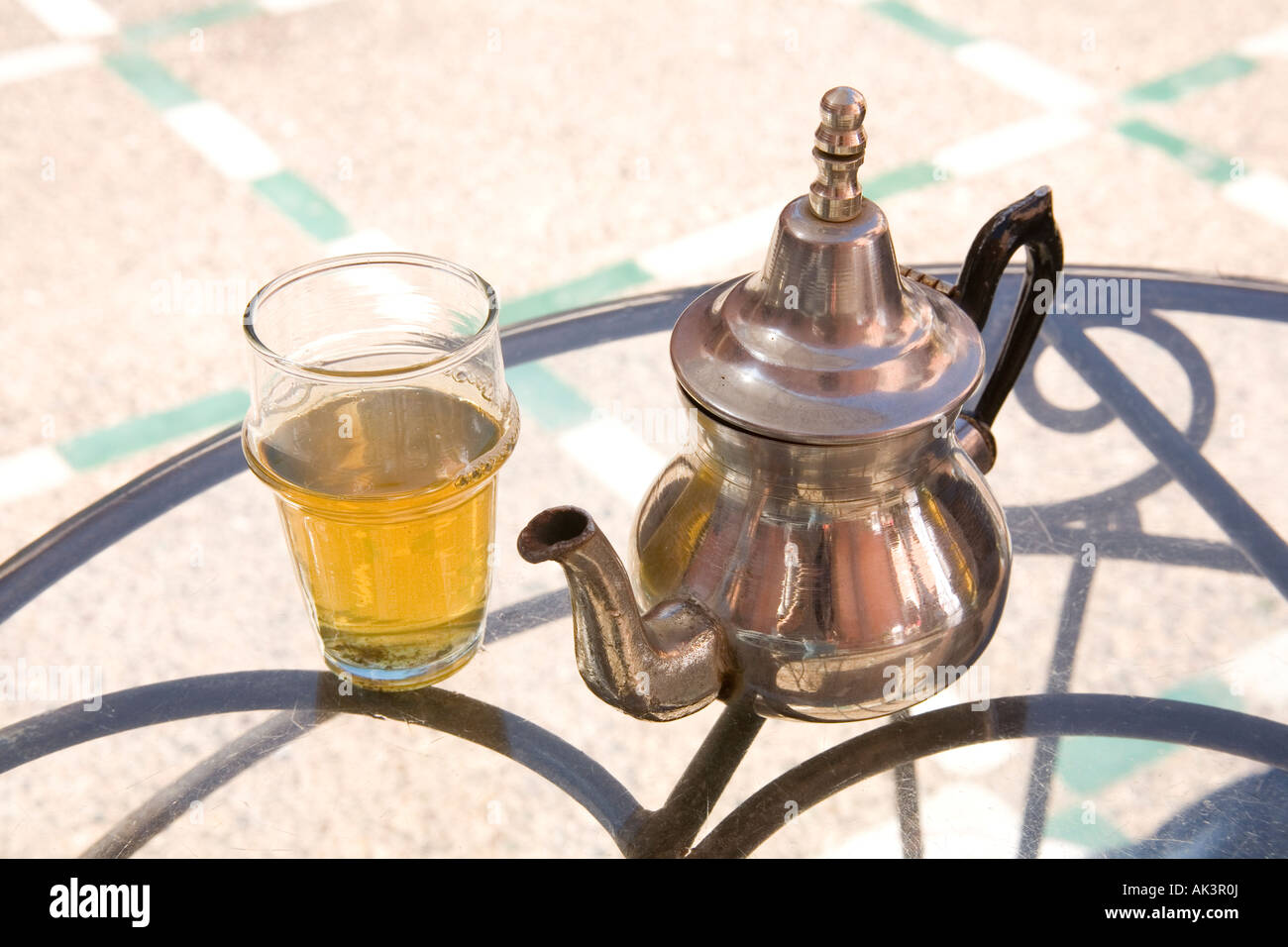 Moroccan glass of mint tea and silver teapot. Marrakech Morocco Stock