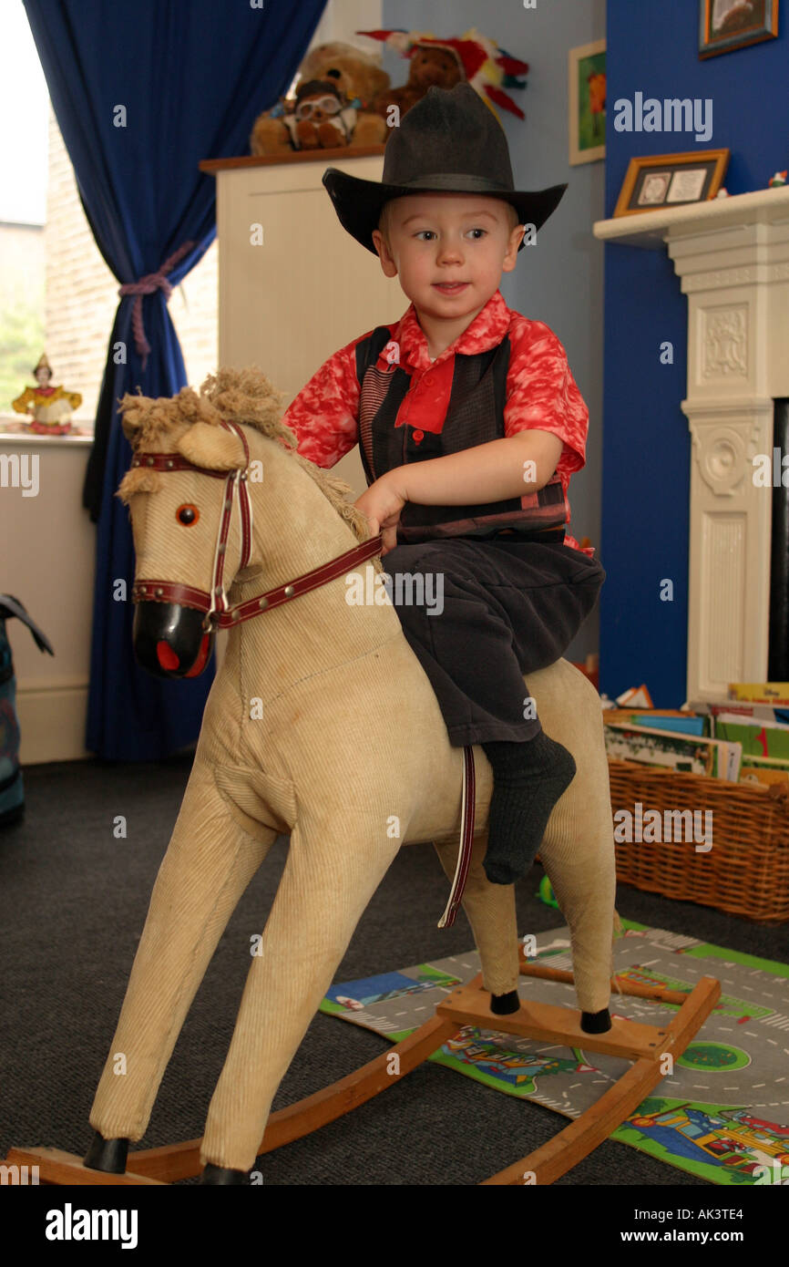 Boy riding rocking horse hi-res stock photography and images - Alamy
