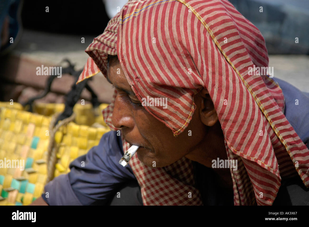 Portrait of a man wearing a kerchief smoking a joint Water Festival Phnom Penh Cambodia Stock Photo