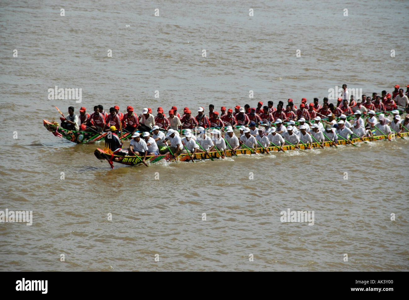 Two big rowing boats in competition with many rowers Water Festival
