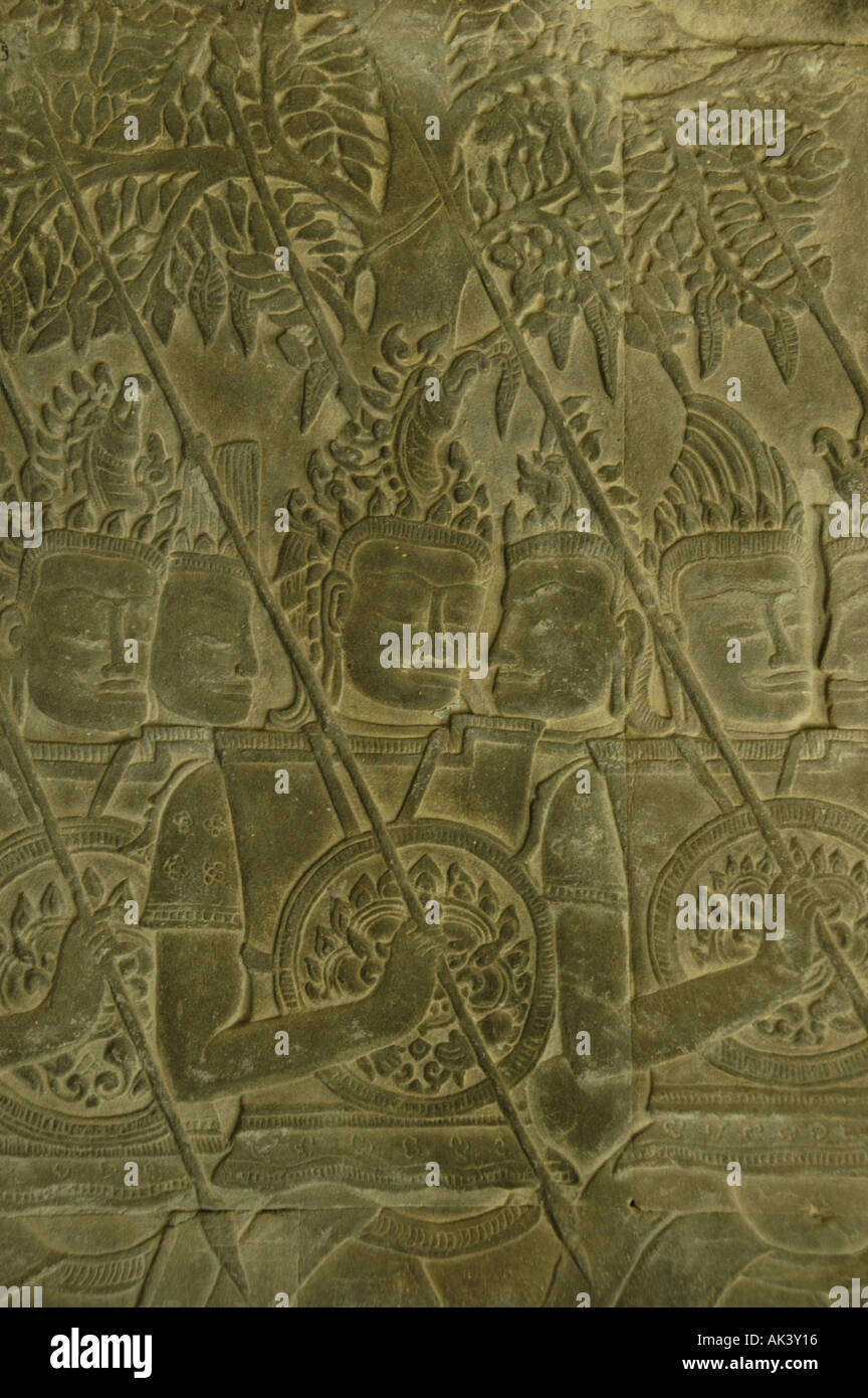 Stone relief of fine arts showing soldiers with speer and shield in front of a tree temple Angkor Wat Siem Reap Cambodia Stock Photo