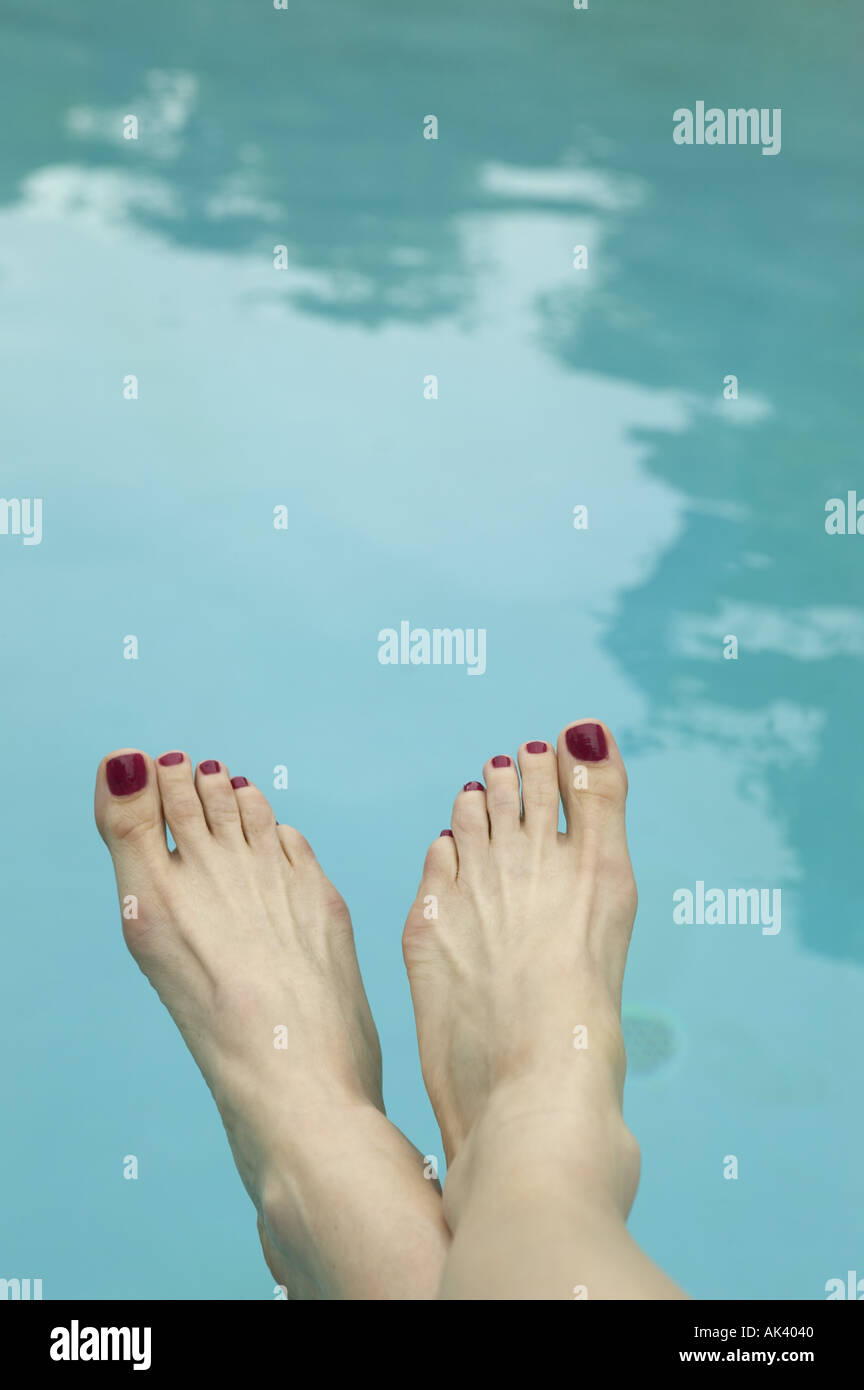 A woman s bare feet by the pool Stock Photo