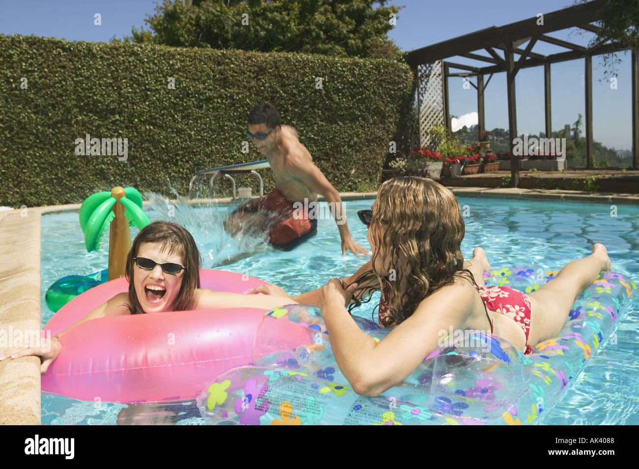 A group of teenage kids playing in a pool Stock Photo