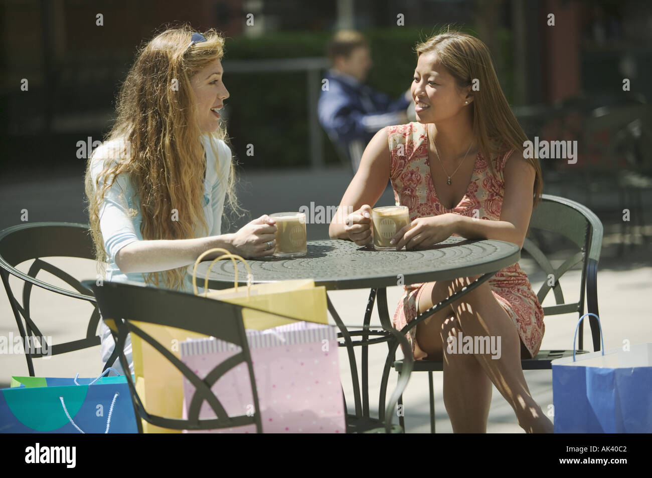 Two friends taking a coffee break after shopping Stock Photo