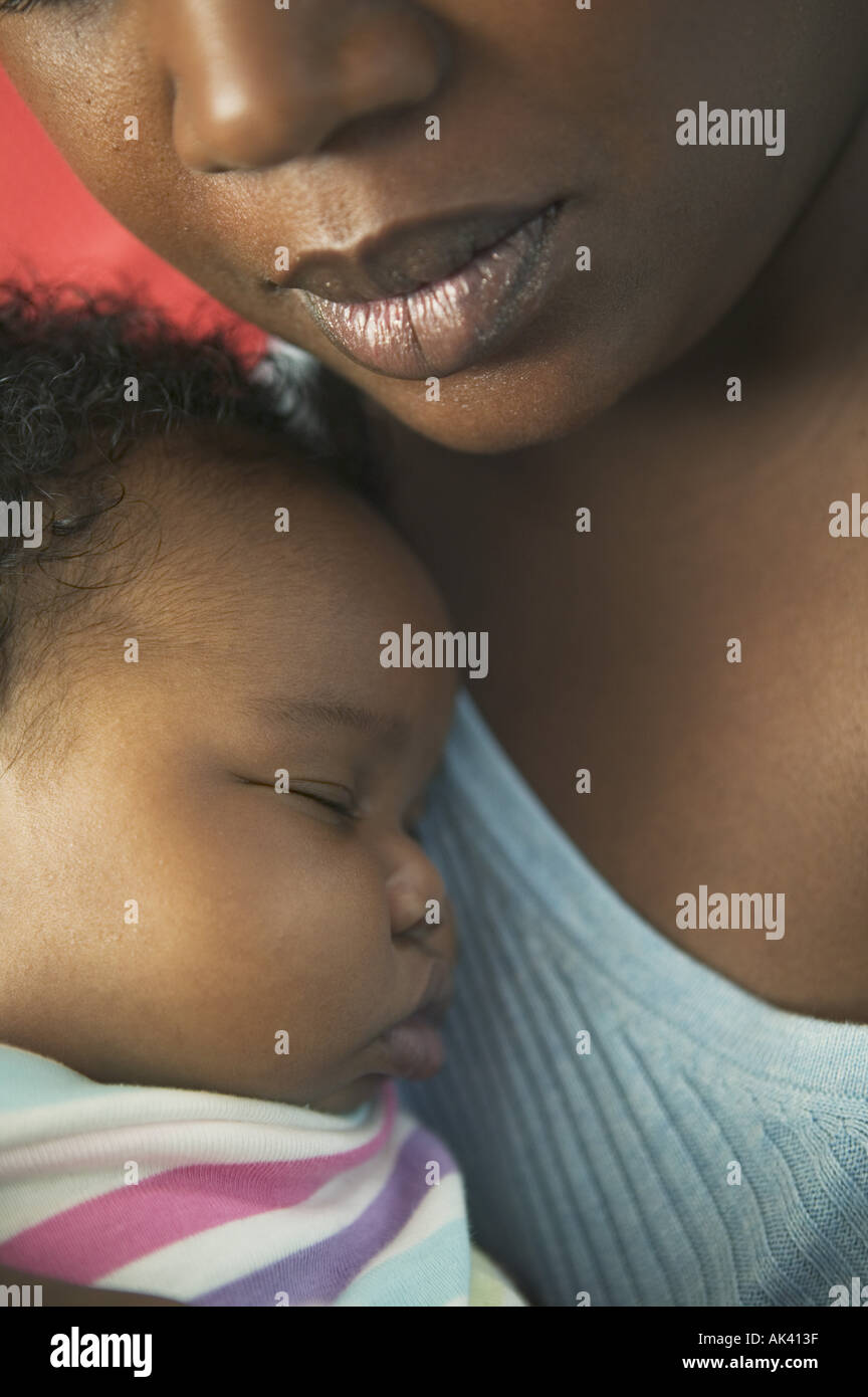 Close up of a baby being held by her mother Stock Photo