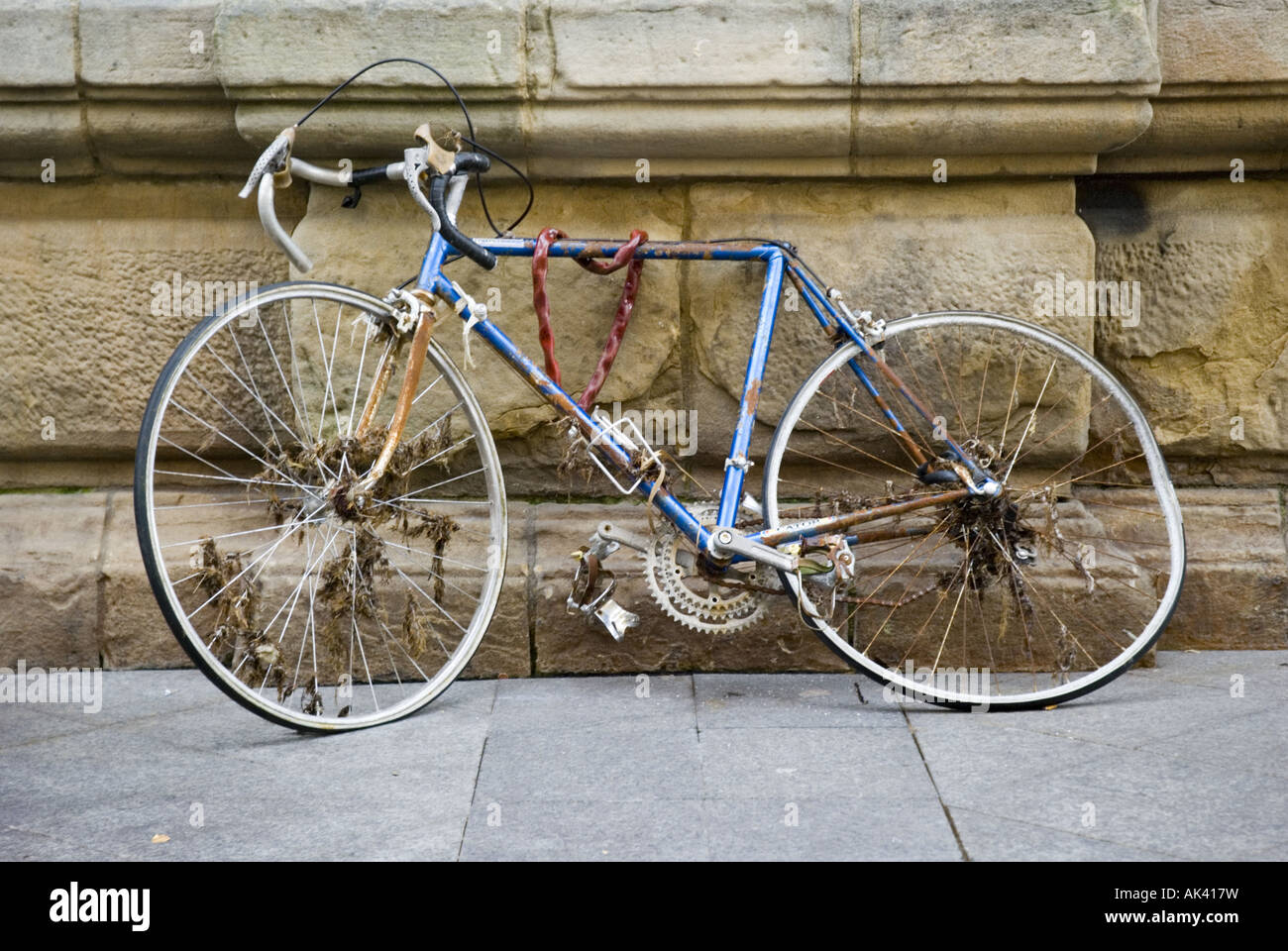 An old racing bicycle leans abandoned against a stone wall in San Sebastian's Old Town, Spain. Stock Photo