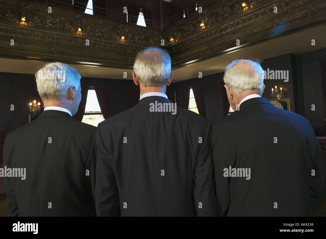 Rear view of three senior men in a dance hall Stock Photo