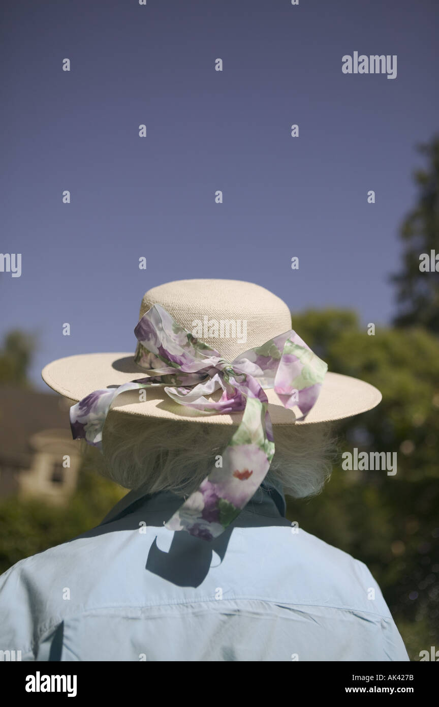 Rear view of a woman wearing a hat with a ribbon Stock Photo