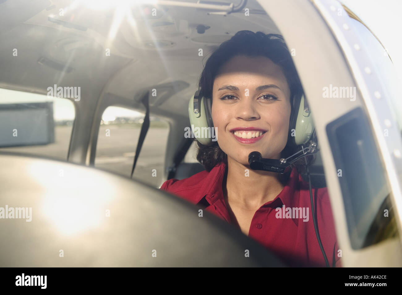 Female pilot in the cockpit of an airplane Stock Photo