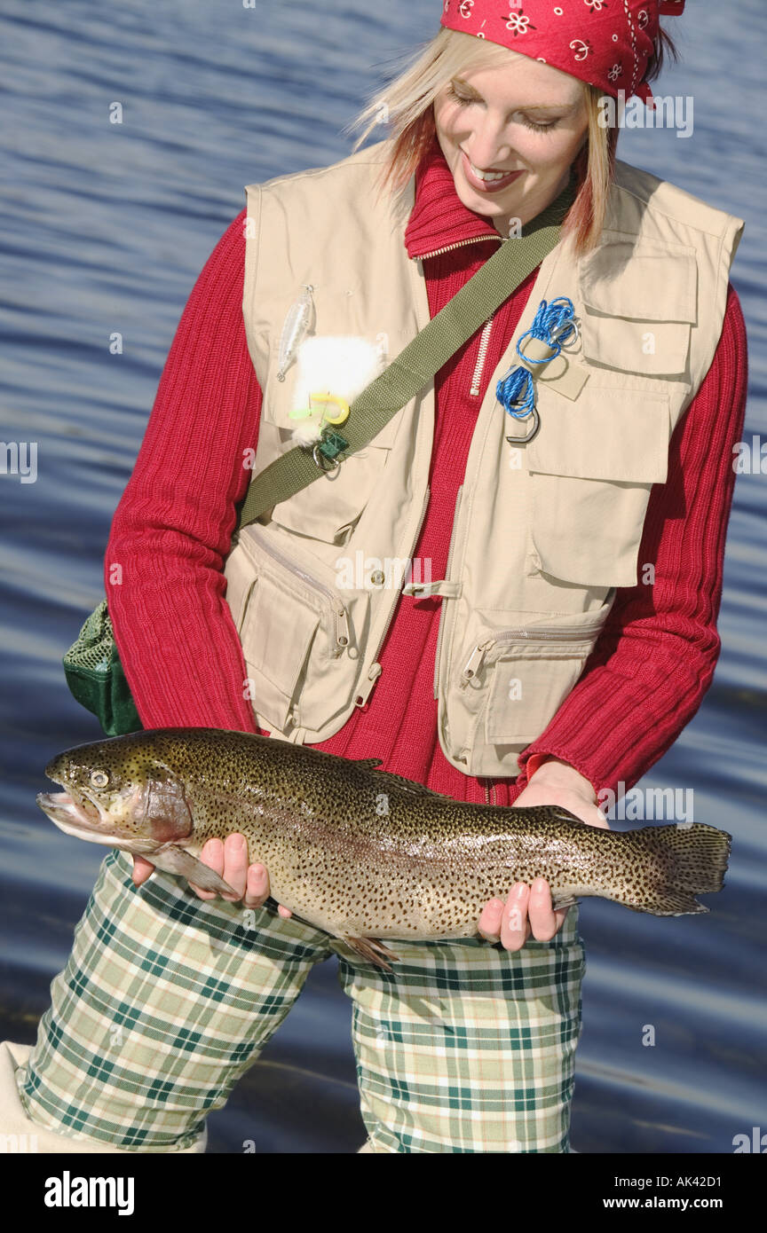 Woman in fishing gear with large trout Stock Photo - Alamy