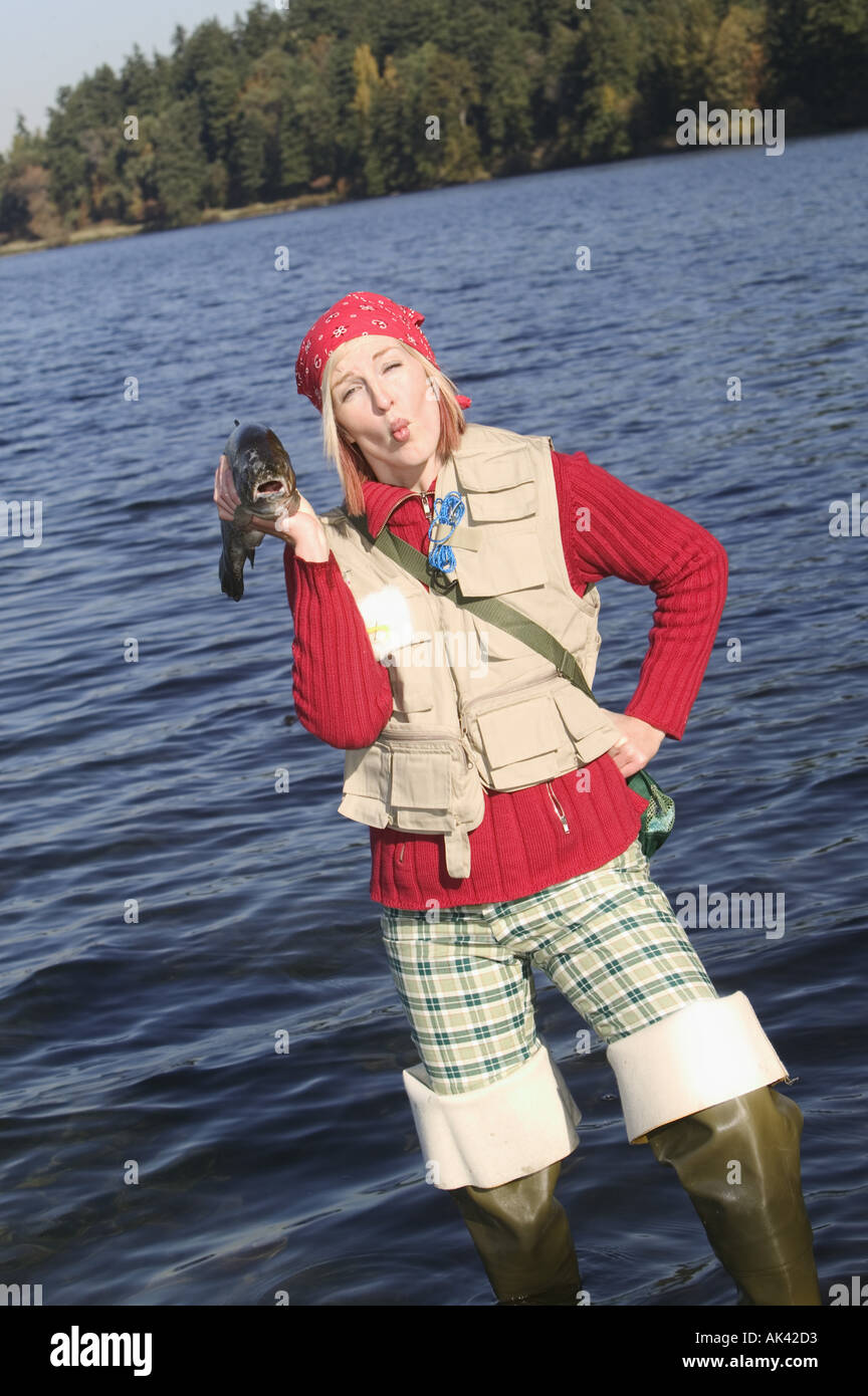 https://c8.alamy.com/comp/AK42D3/woman-in-fishing-gear-posing-playfully-AK42D3.jpg