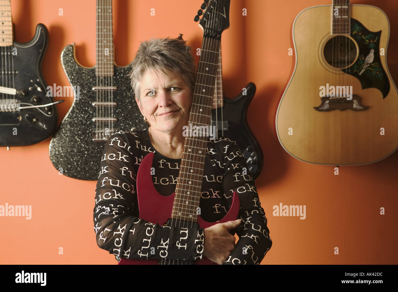 Portrait of a woman and her guitars Stock Photo - Alamy