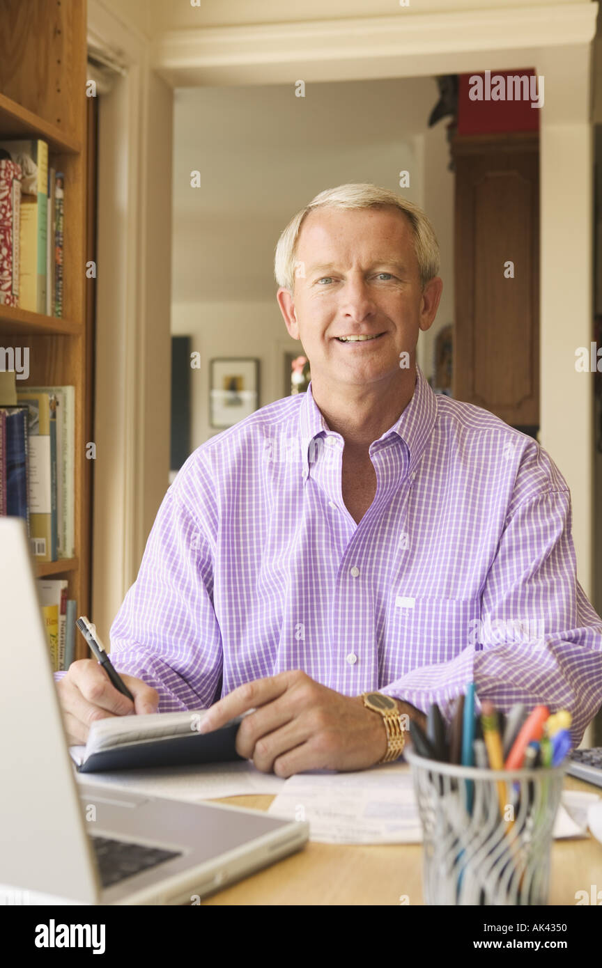 Man Write Check Man writing checks in his home office Stock Photo - Alamy