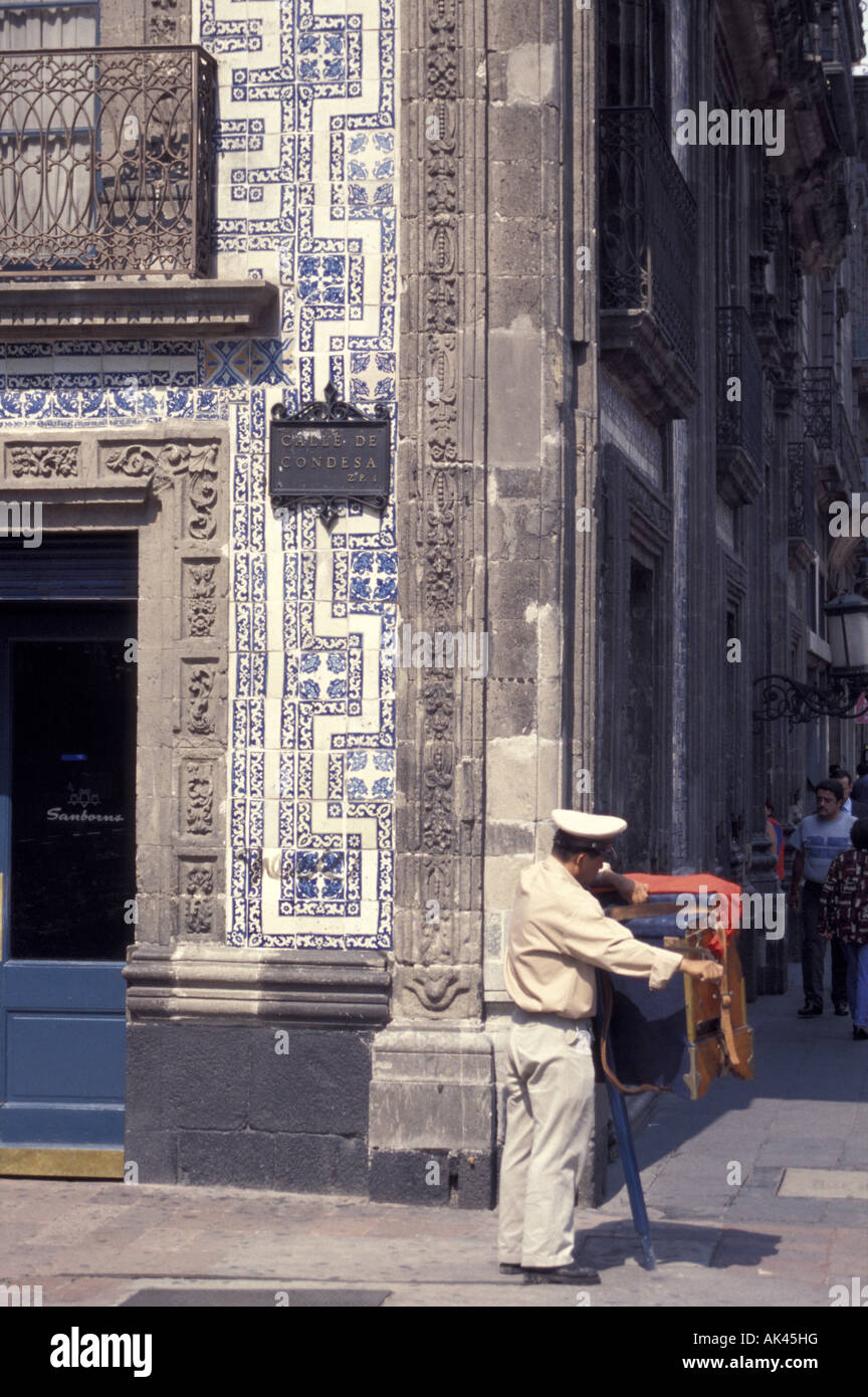 Organ grinder outside the Casa de los Azulejos or House of Tiles in downtown Mexico City Stock Photo