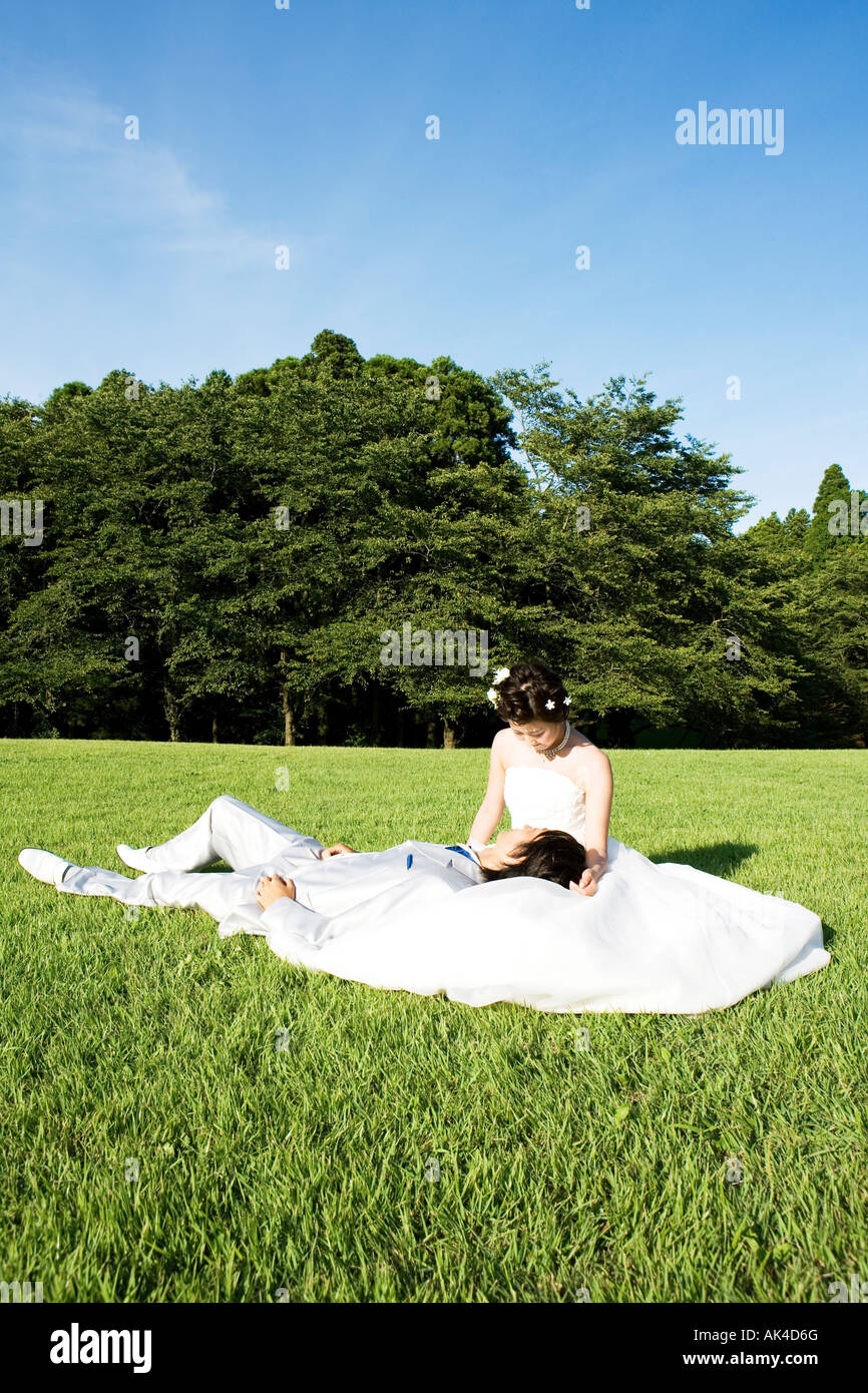 Bride groom lying on grass hi-res stock photography and images - Alamy