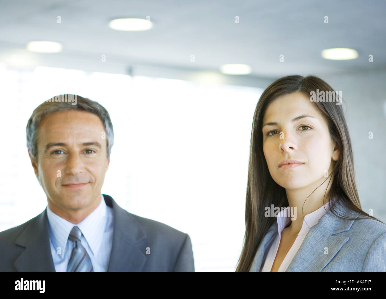 Mature businessman and young businesswoman, looking at camera Stock Photo