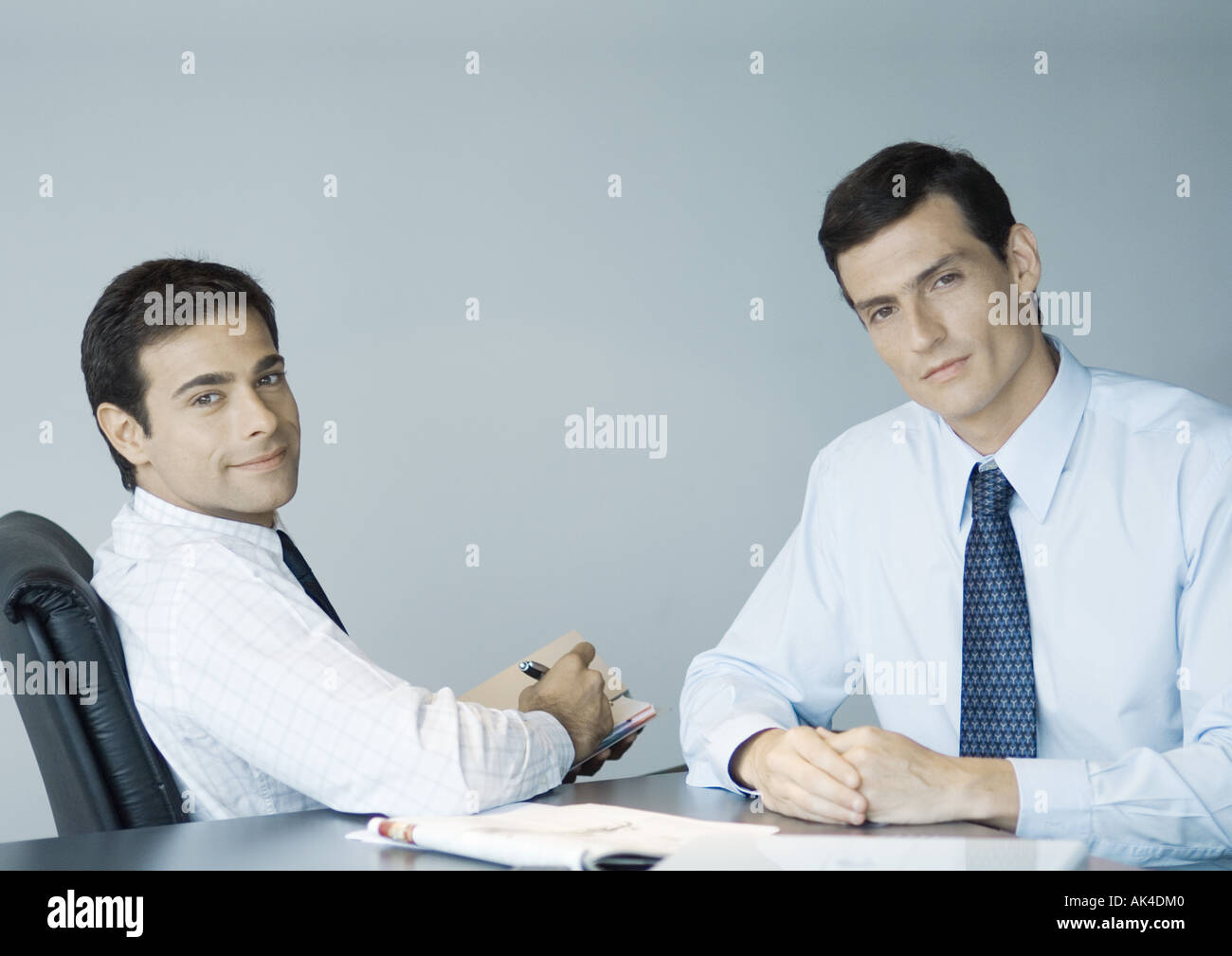 Business colleagues working together, smiling at camera Stock Photo