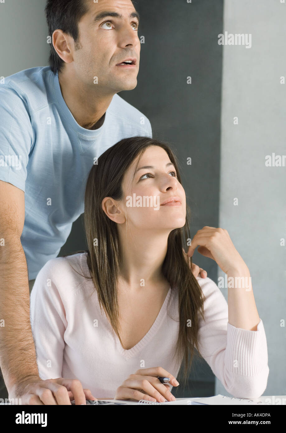 Couple looking up together, smiling Stock Photo