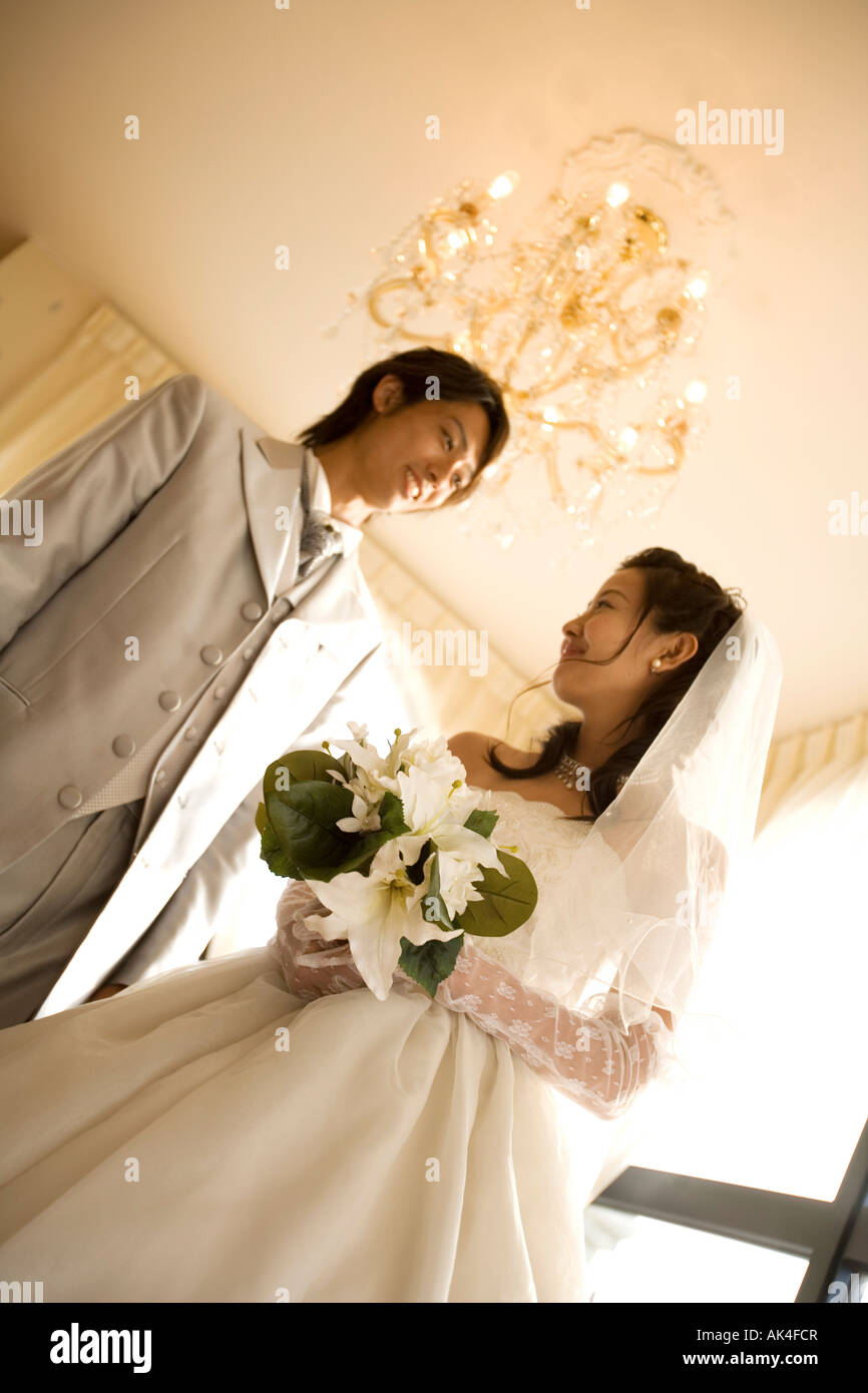 Bride and groom standing in a room, low angle view Stock Photo - Alamy