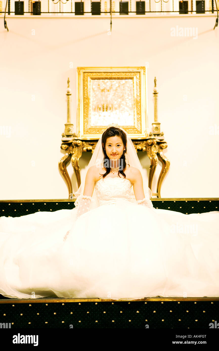 Portrait of bride sitting on staircase Stock Photo - Alamy