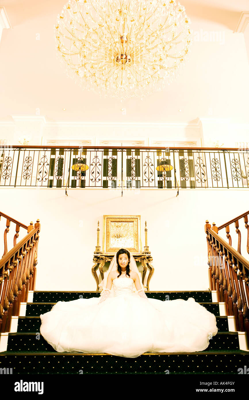 Portrait of bride sitting on steps Stock Photo - Alamy