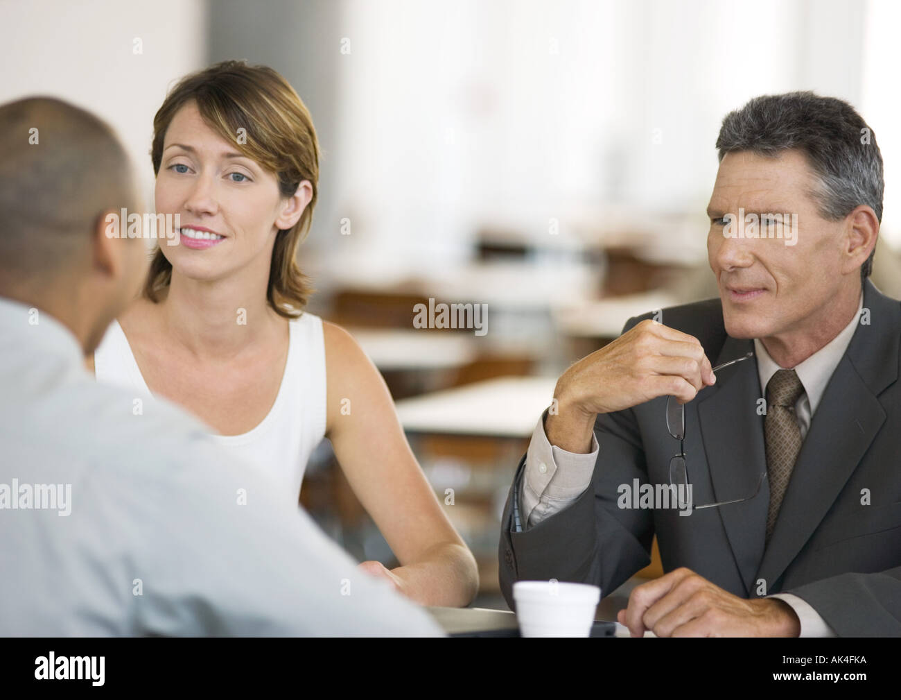 Three business colleagues having conversation Stock Photo