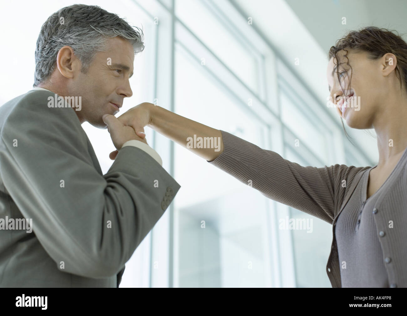 Man kissing woman's hand Stock Photo - Alamy