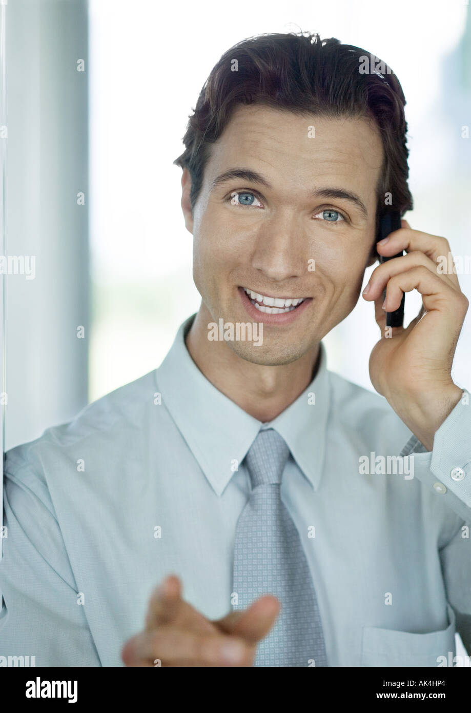 Businessman phoning and smiling Stock Photo