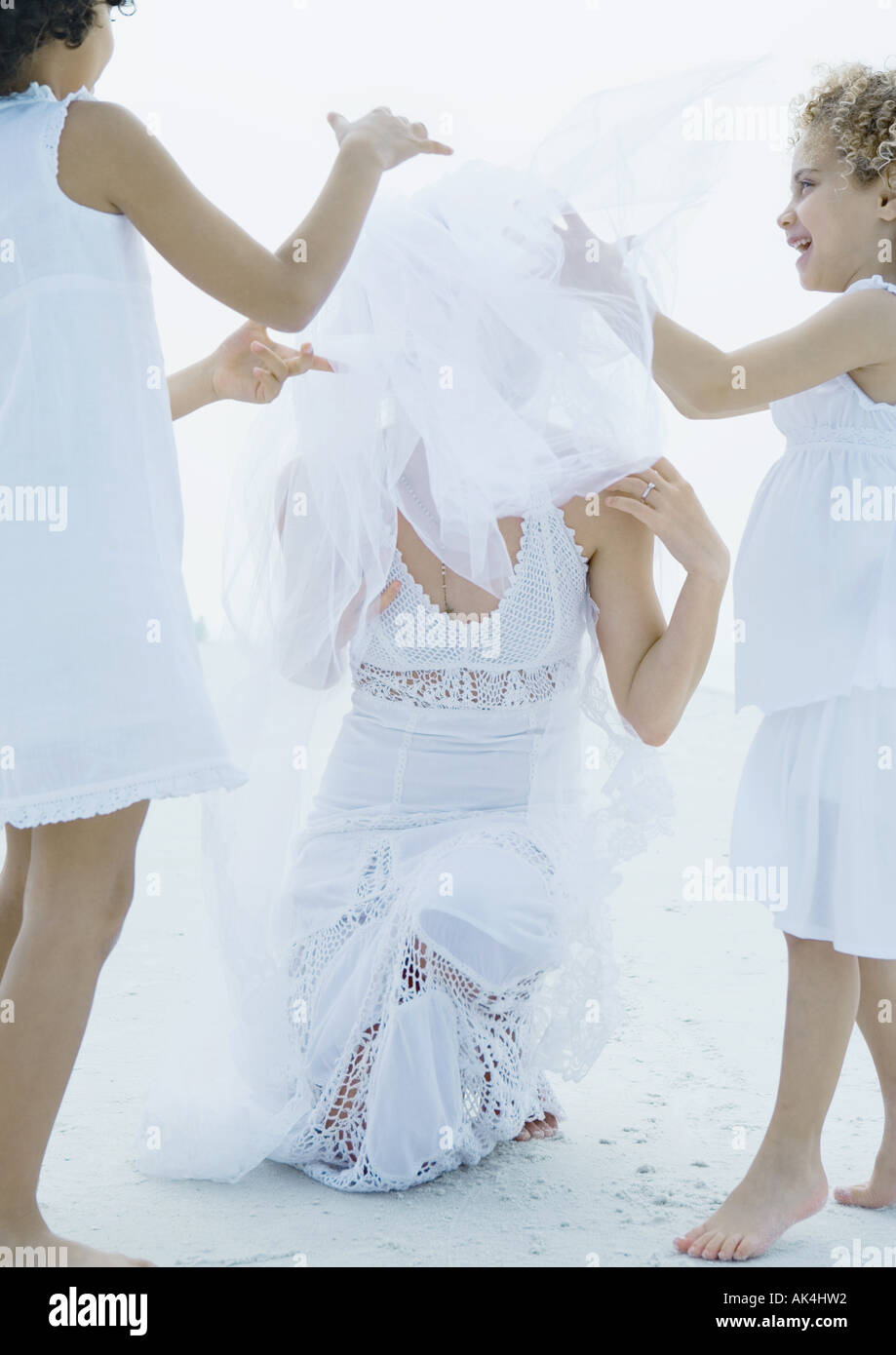 Two girls helping bride fix veil Stock Photo Alamy