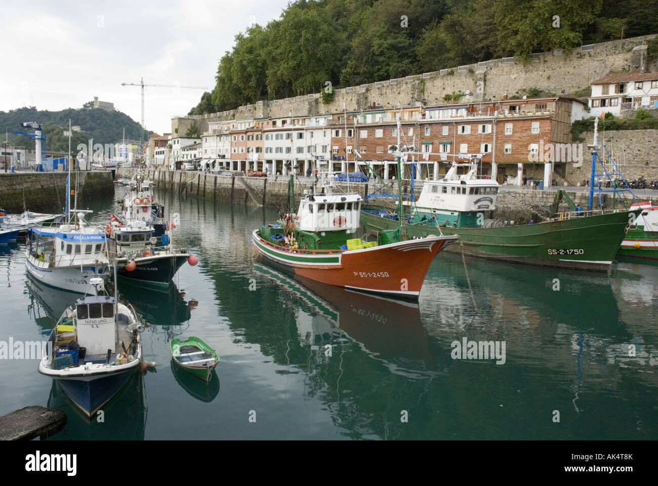 Fishing boats in the stone harbour in San Sebastian's historic Old Town, Spain. Stock Photo