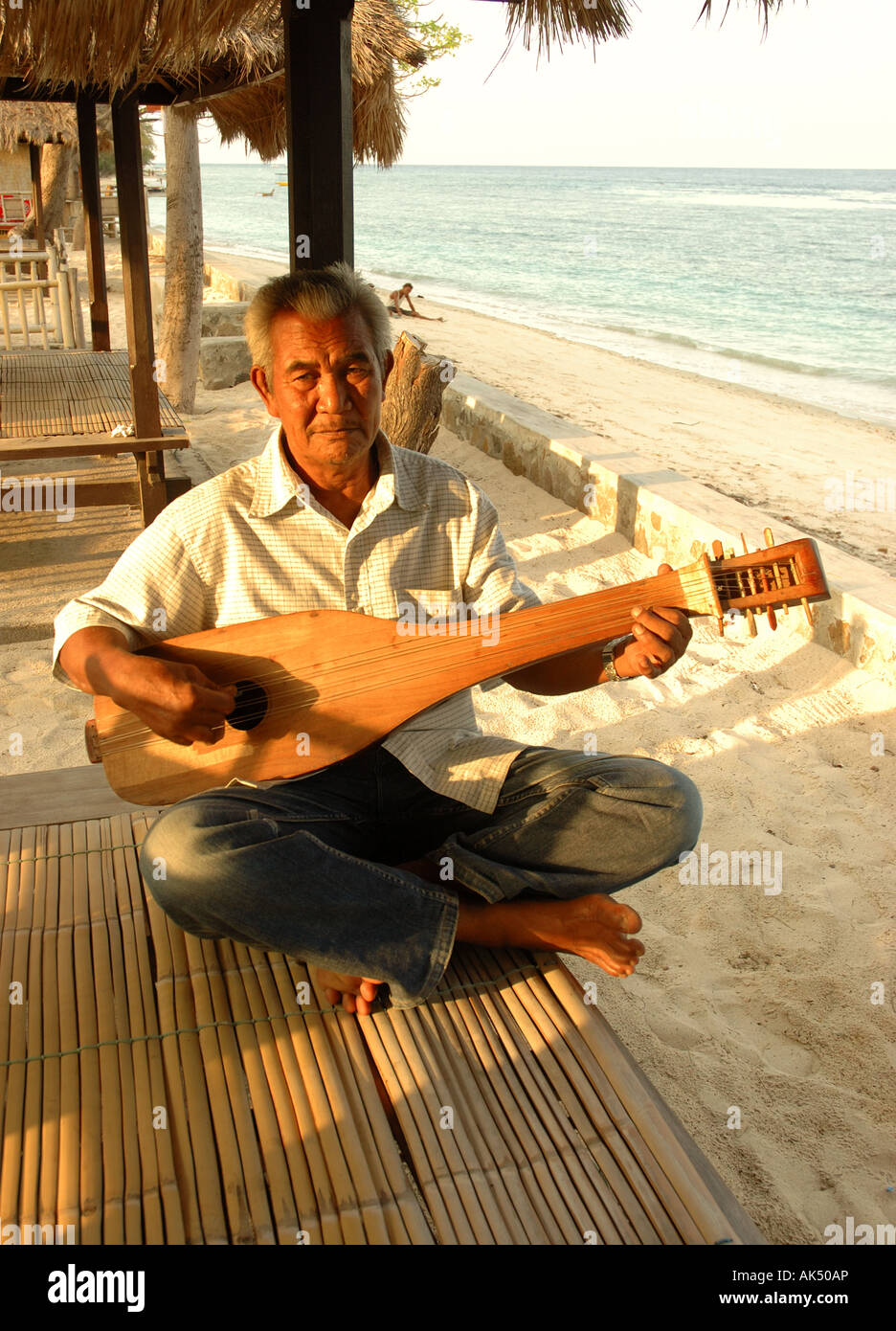 Old man with his guitar on Gili Air, Gili Islands, Indonesia Stock Photo