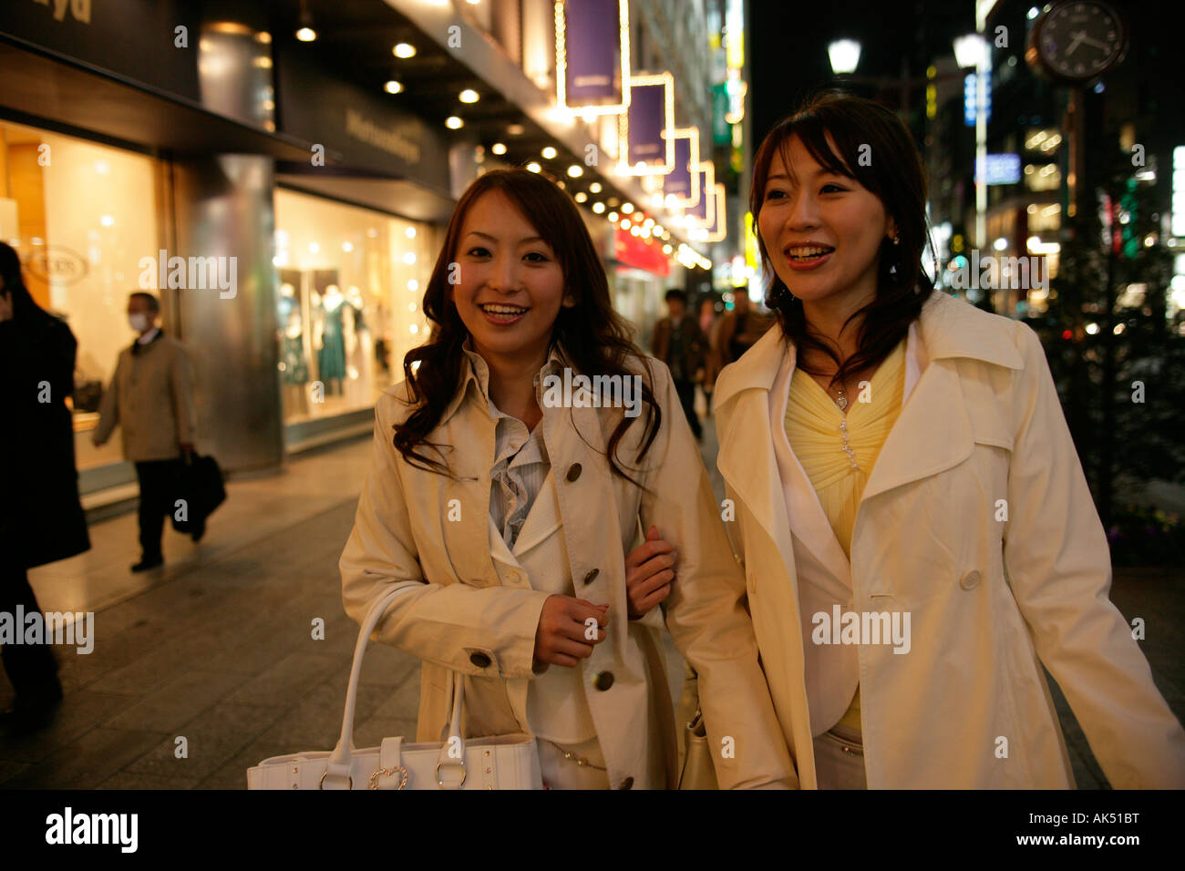 Two women walking on the street at night Stock Photo - Alamy